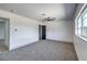 Spacious bedroom with gray carpet, ceiling fan, and window with natural light at 4012 Mira Ln, Las Vegas, NV 89108