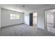 Inviting bedroom with gray carpeting, a window, a walk-in closet, and an open door at 4012 Mira Ln, Las Vegas, NV 89108