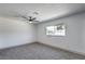Inviting bedroom features a ceiling fan, plush gray carpet and a window at 4012 Mira Ln, Las Vegas, NV 89108