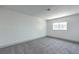 Bright bedroom features a window, plush gray carpeting, and neutral-colored walls at 4012 Mira Ln, Las Vegas, NV 89108