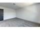 Cozy bedroom features a gray carpet, neutral-colored walls, and a sleek black door at 4012 Mira Ln, Las Vegas, NV 89108