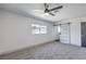 Comfortable bedroom with plush gray carpeting, and a sliding barn door entrance at 4012 Mira Ln, Las Vegas, NV 89108