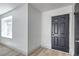 Bright entryway featuring new laminate flooring, a side window, and a modern-style black front door at 4012 Mira Ln, Las Vegas, NV 89108