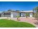 Inviting single-story home with a manicured lawn, desert landscaping, and a freshly painted exterior at 4012 Mira Ln, Las Vegas, NV 89108