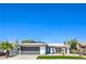Charming single-story home featuring a well-maintained front yard and a gray two-car garage door at 4012 Mira Ln, Las Vegas, NV 89108