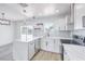 Bright kitchen features stainless steel appliances, white cabinets, breakfast bar and pendant lighting at 4012 Mira Ln, Las Vegas, NV 89108
