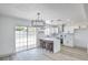 Bright kitchen features stainless steel appliances, white cabinets, breakfast bar and pendant lighting at 4012 Mira Ln, Las Vegas, NV 89108