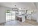 Bright kitchen features stainless steel appliances, white cabinets, breakfast bar and pendant lighting at 4012 Mira Ln, Las Vegas, NV 89108
