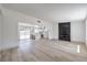 Bright, open-concept living area featuring sleek flooring, a fireplace, and a seamless flow into the kitchen at 4012 Mira Ln, Las Vegas, NV 89108