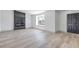 Bright living area with modern flooring, a striking fireplace, and a freshly painted black front door at 4012 Mira Ln, Las Vegas, NV 89108
