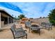 Backyard with outdoor seating area, lush landscaping, rock waterfall and inground pool at 4578 Churchfield Cir, Las Vegas, NV 89103