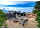 Backyard with outdoor seating area, lush landscaping, rock waterfall and inground pool at 4578 Churchfield Cir, Las Vegas, NV 89103