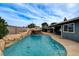 Backyard pool featuring rock waterfall and slide with covered patio and outdoor seating at 4578 Churchfield Cir, Las Vegas, NV 89103