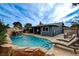 Backyard pool featuring rock waterfall, and comfortable lounge chairs with covered patio at 4578 Churchfield Cir, Las Vegas, NV 89103