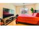 Bright bedroom featuring wood floors, a large TV, and a comfortable-looking bed at 5536 Baccarat Ave # 101, Las Vegas, NV 89122