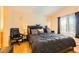 Spacious bedroom boasts wood floors, a large window, and a comfortable queen-size bed at 5536 Baccarat Ave # 101, Las Vegas, NV 89122