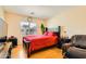 Well-lit bedroom with window, red accents, a queen-sized bed, and TV at 5536 Baccarat Ave # 101, Las Vegas, NV 89122