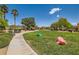 Community park with walking paths, lush green grass, mature trees, seating, and whimsical frog statues at 5536 Baccarat Ave # 101, Las Vegas, NV 89122