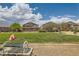 Community park featuring well-maintained green space with nearby residential buildings and shady mature trees on a sunny day at 5536 Baccarat Ave # 101, Las Vegas, NV 89122