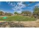 Beautiful community park with lush green grass, mature trees, and play equipment under a bright blue sky at 5536 Baccarat Ave # 101, Las Vegas, NV 89122