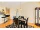 Well-lit dining area featuring a modern table, hardwood floors, and breakfast bar at 5536 Baccarat Ave # 101, Las Vegas, NV 89122