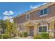 Well-maintained townhome features shuttered windows, desert landscaping, and a covered front porch at 5536 Baccarat Ave # 101, Las Vegas, NV 89122