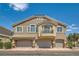 Exterior shot of a two-story townhome with garages and a small balcony at 5536 Baccarat Ave # 101, Las Vegas, NV 89122