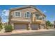 Charming three-story townhome featuring multiple garages and a private balcony on a sunny day at 5536 Baccarat Ave # 101, Las Vegas, NV 89122