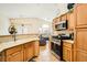 Well-lit kitchen with bar, granite countertops, and stainless steel appliances at 5536 Baccarat Ave # 101, Las Vegas, NV 89122