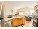 Bright kitchen with stainless appliances, breakfast bar overlooking the living room at 5536 Baccarat Ave # 101, Las Vegas, NV 89122