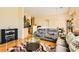 Cozy living room with plush seating, modern entertainment center and light hardwood floors at 5536 Baccarat Ave # 101, Las Vegas, NV 89122