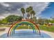 Colorful splash pad area in the community park, surrounded by palm trees and green spaces at 5536 Baccarat Ave # 101, Las Vegas, NV 89122