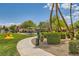 Community park featuring a winding sidewalk, lush landscaping, and play areas for recreation at 5536 Baccarat Ave # 101, Las Vegas, NV 89122
