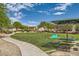 Picturesque community park featuring a walking path, green spaces, picnic area, and playful sculptures at 5536 Baccarat Ave # 101, Las Vegas, NV 89122