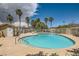Sparkling community pool surrounded by palm trees and lounge chairs for relaxation on a sunny day at 5536 Baccarat Ave # 101, Las Vegas, NV 89122