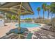 Inviting community pool area with shaded picnic table and lounge chairs under sunny skies at 5536 Baccarat Ave # 101, Las Vegas, NV 89122