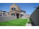 Backyard showcasing the home's architecture, a small patch of turf and lounge chairs at 6294 Redstone Hills Dr, Las Vegas, NV 89148