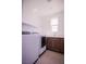 Bright laundry room includes a white washer and dryer, cabinets, countertop, sink and window at 6294 Redstone Hills Dr, Las Vegas, NV 89148