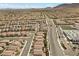 Aerial view of a community with uniform housing, a central school, and neatly arranged streets for organized living at 8107 Skye Sweep St, Las Vegas, NV 89166