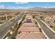 An aerial view of homes with terracotta roofs in a planned community with desert landscaping at 8107 Skye Sweep St, Las Vegas, NV 89166