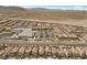 A neighborhood with neat rows of houses, a school, and well-organized parking, all set against a mountain backdrop at 8107 Skye Sweep St, Las Vegas, NV 89166