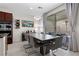 Elegant dining area featuring a large table and modern light fixture, seamlessly connected to the kitchen at 8107 Skye Sweep St, Las Vegas, NV 89166
