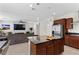 Stylish kitchen island with stainless steel fridge and views of the living room, perfect for entertaining at 8107 Skye Sweep St, Las Vegas, NV 89166