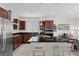 Well-equipped kitchen with granite counters, stainless steel appliances, and dark wood cabinetry at 8107 Skye Sweep St, Las Vegas, NV 89166
