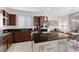 Well-appointed kitchen featuring dark wood cabinetry, granite countertops, and stainless steel appliances at 8107 Skye Sweep St, Las Vegas, NV 89166