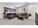 Spacious living room with large sectional sofa, accent plants, and natural lighting at 8107 Skye Sweep St, Las Vegas, NV 89166