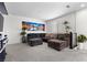 Spacious living room with large sectional sofa, accent plants, and natural lighting at 8107 Skye Sweep St, Las Vegas, NV 89166