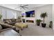 Stylish living room boasts a modern fireplace, large ceiling fan, and plenty of natural light at 8107 Skye Sweep St, Las Vegas, NV 89166