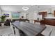 Open-concept living space featuring tile flooring, a fireplace, and a modern kitchen with stainless steel appliances at 8107 Skye Sweep St, Las Vegas, NV 89166