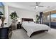 Serene main bedroom featuring dark wood furniture, neutral tones, and sliding glass door to the backyard at 8107 Skye Sweep St, Las Vegas, NV 89166